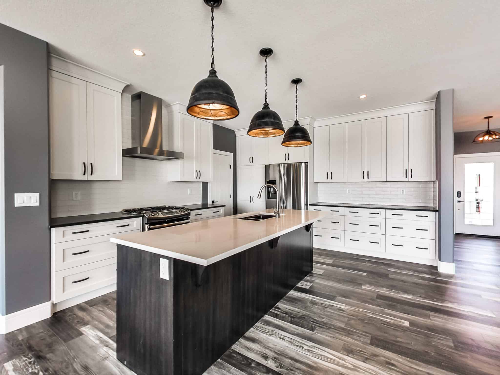 kitchen space with large island and industrial style pendant lighting