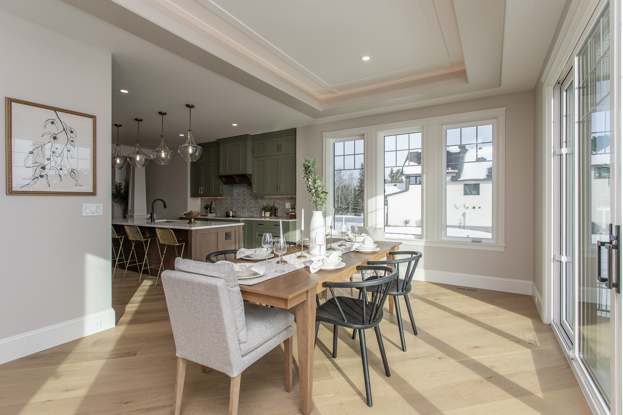 craftsman-style home kitchen in background and dining area with large table in foreground