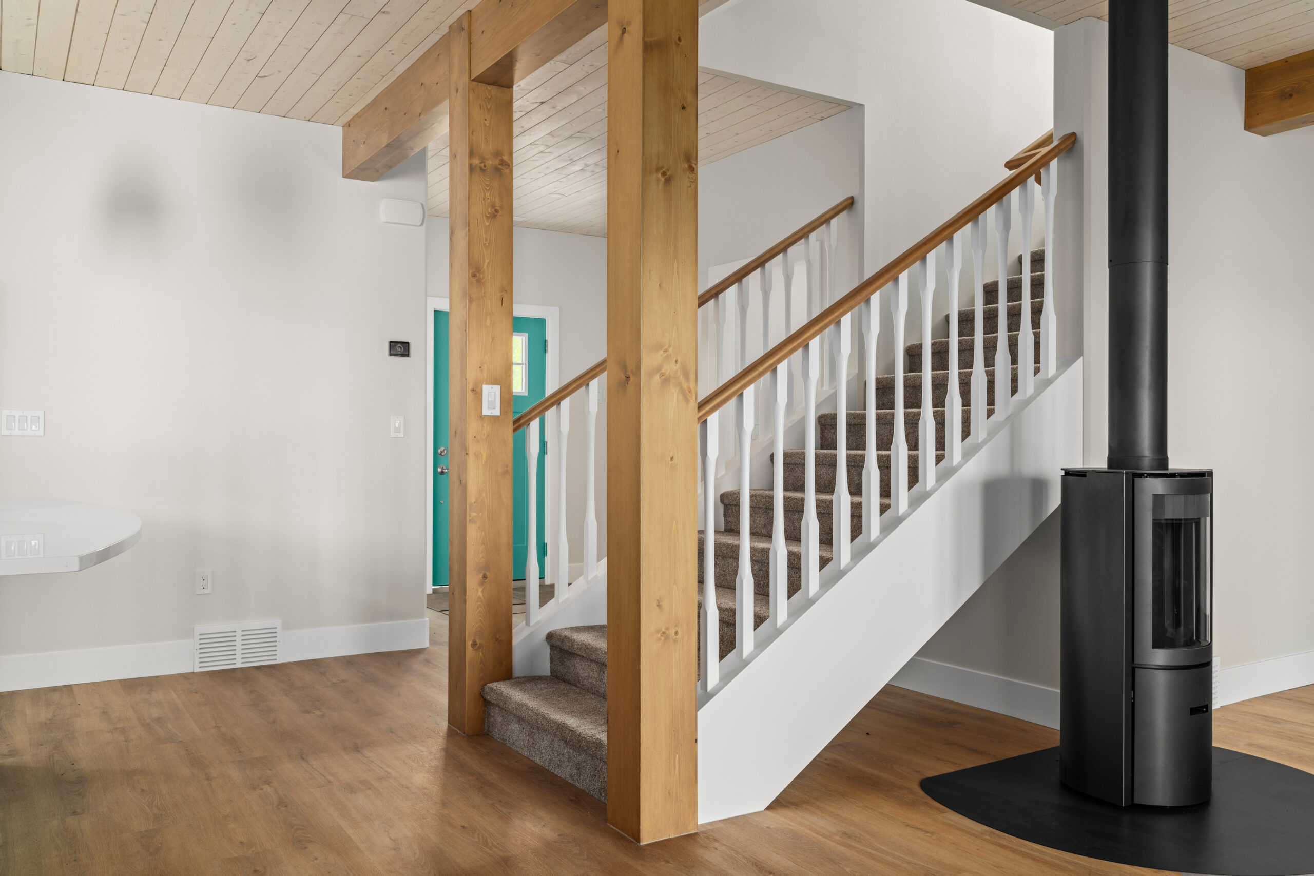 stairwell going upstairs with wood burning fireplace to the side