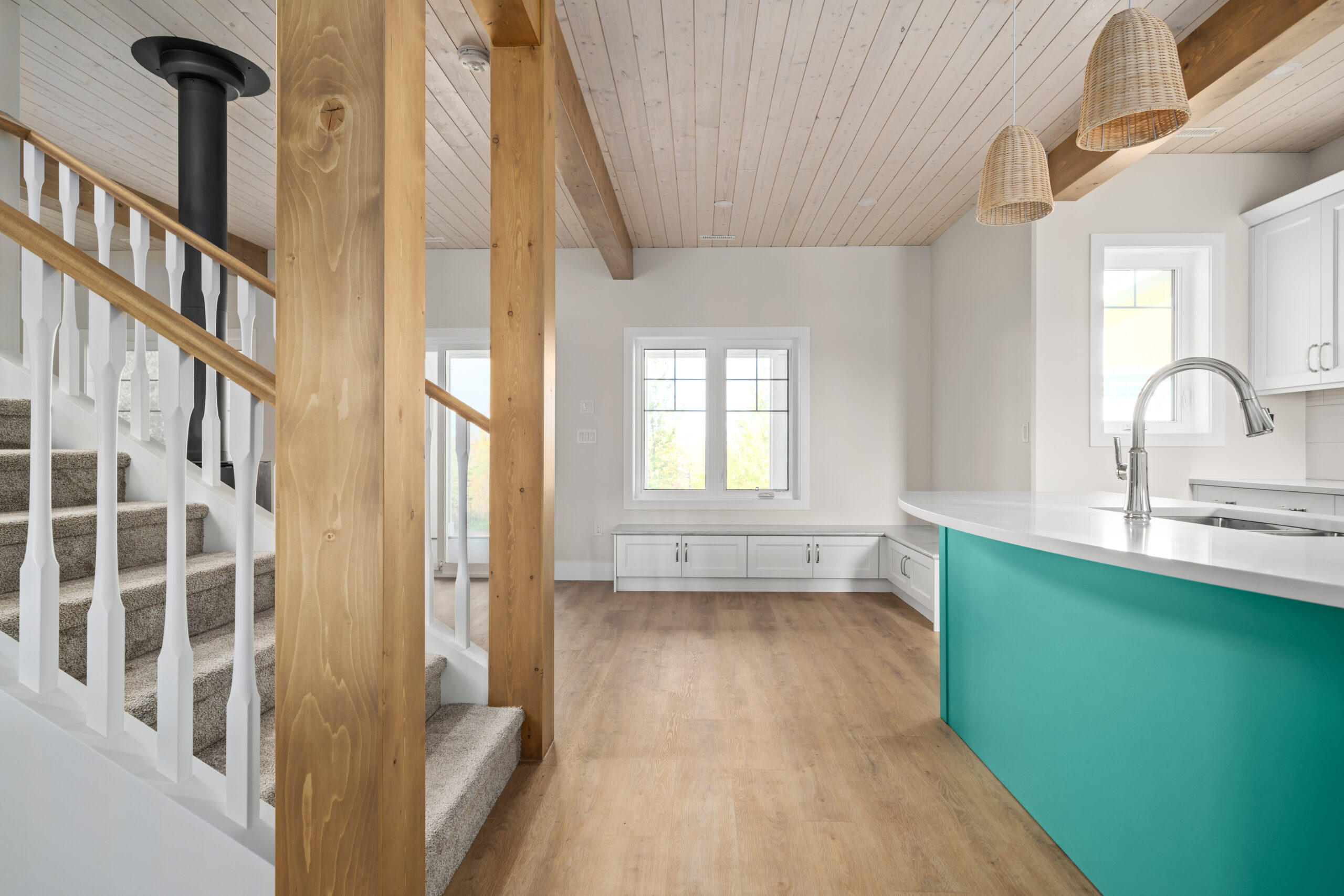 blue kitchen island on right, stairwell going up on the left, built-in benches with storage ahead