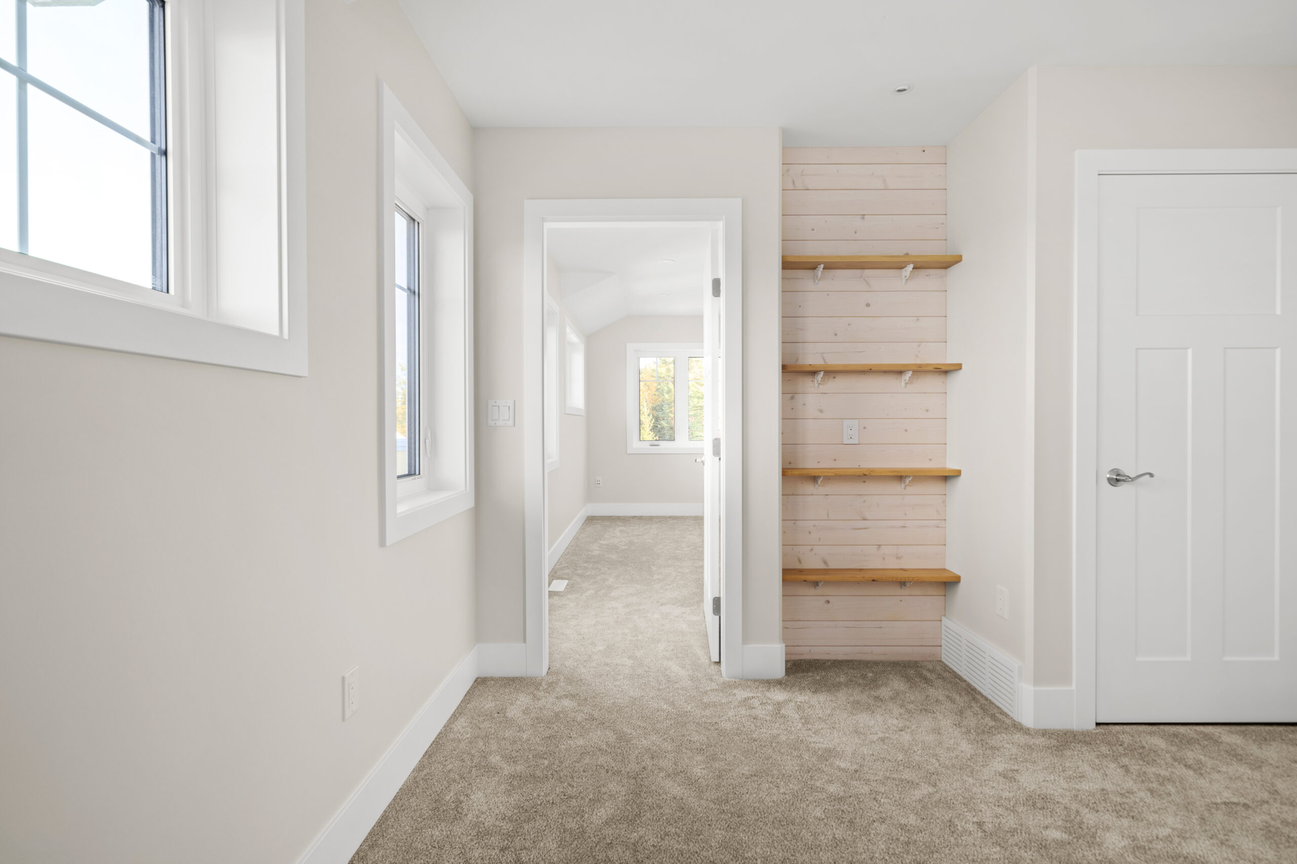 doorway into bedroom with built-in open shelving to the right