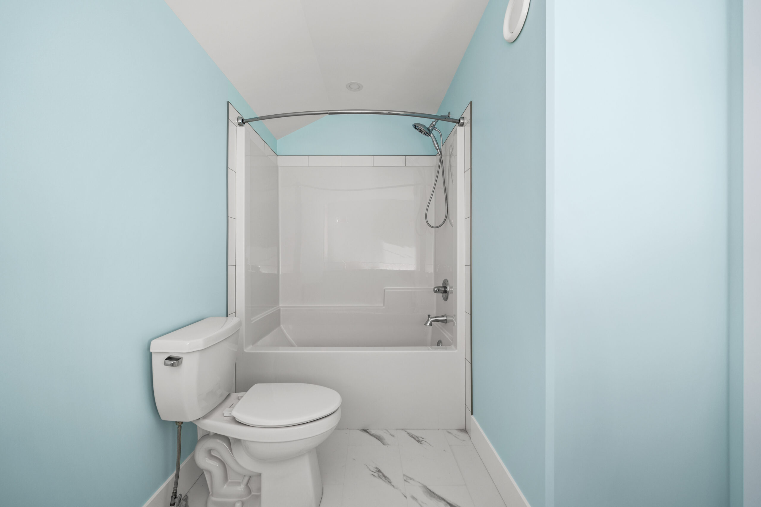 Shower, bath tub and toilet in bathroom