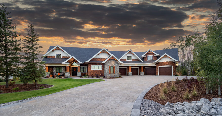 estate home with stormy sky behind