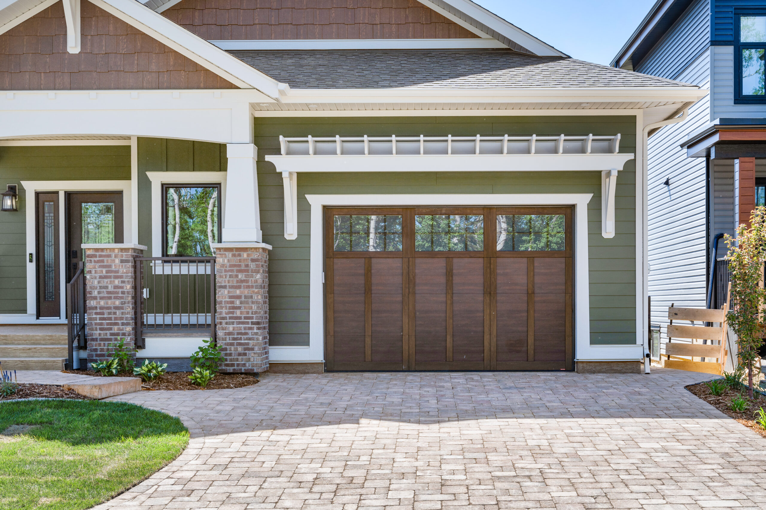 custom craftsman bungalow home built by Vleeming Custom Homes with pergola detail over garage door