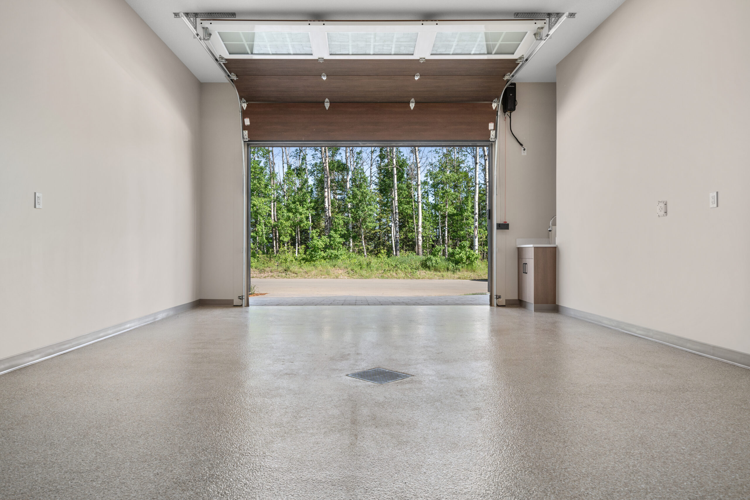 interior of a garage, looking out onto green space