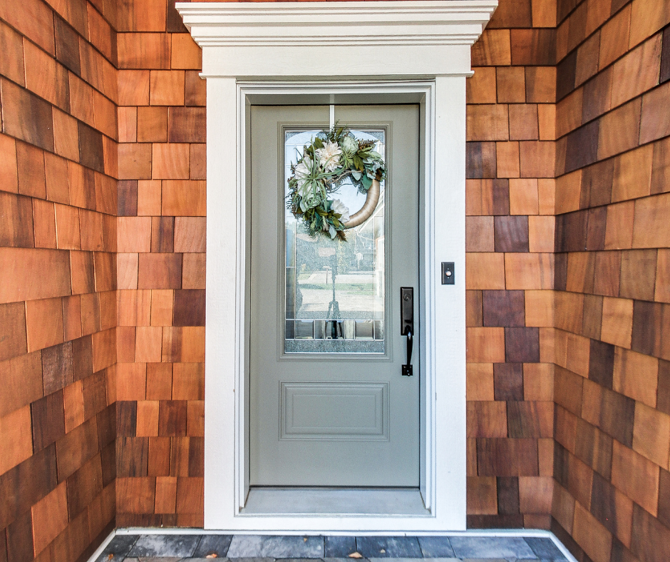 wreath on front door, cedar shake siding