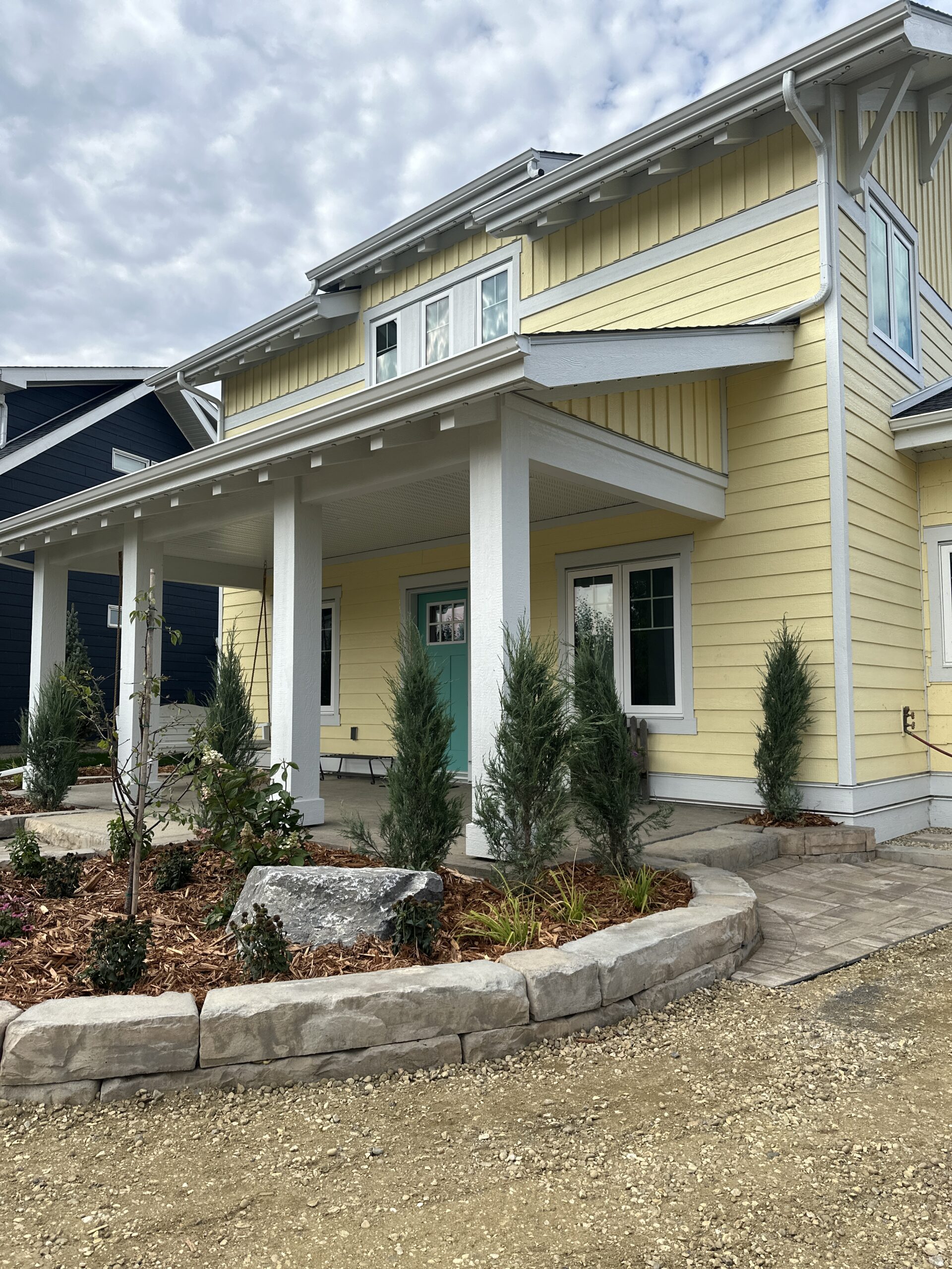 front covered veranda on a yellow-sided home