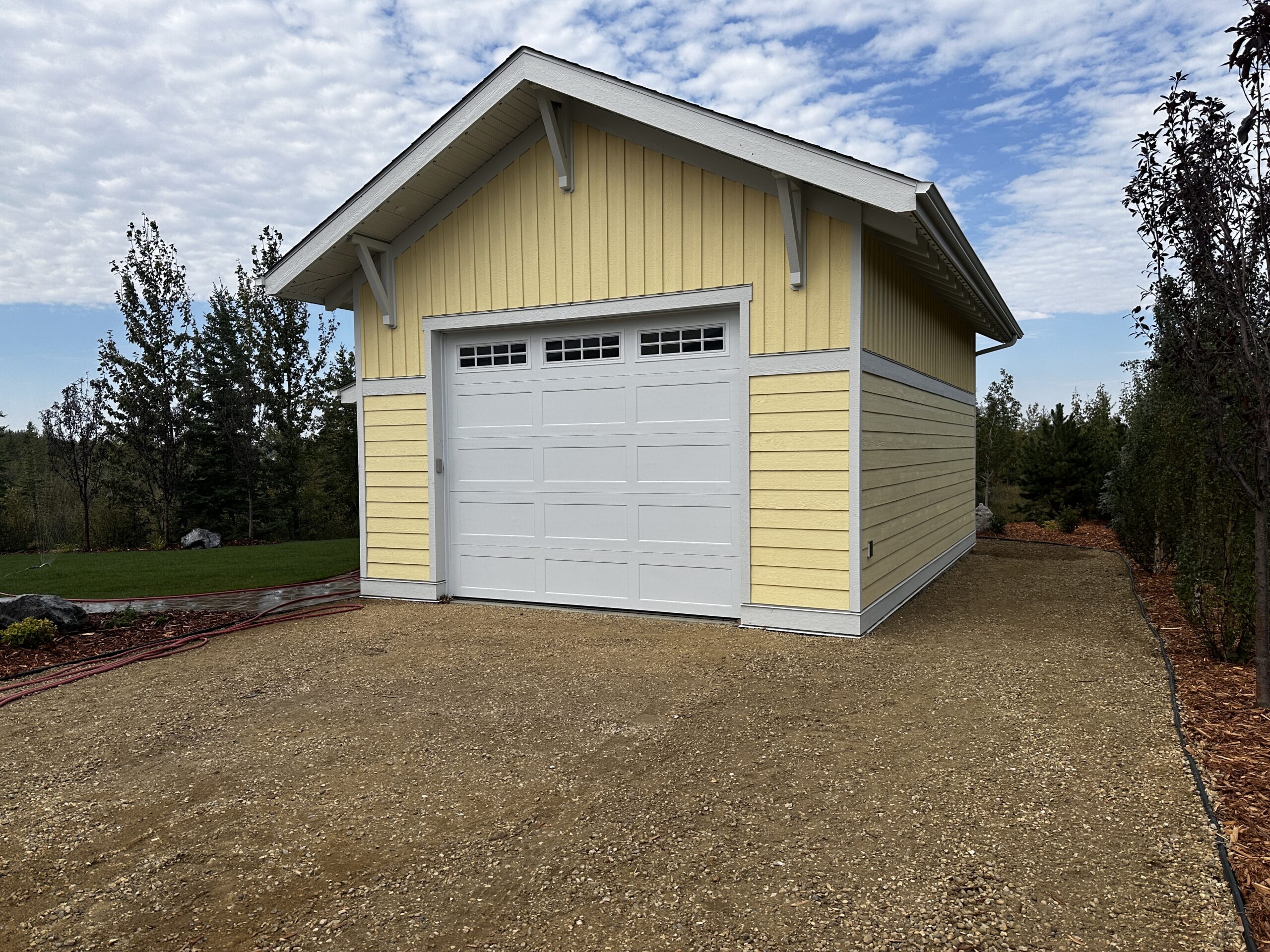 tall, yellow-sided garage