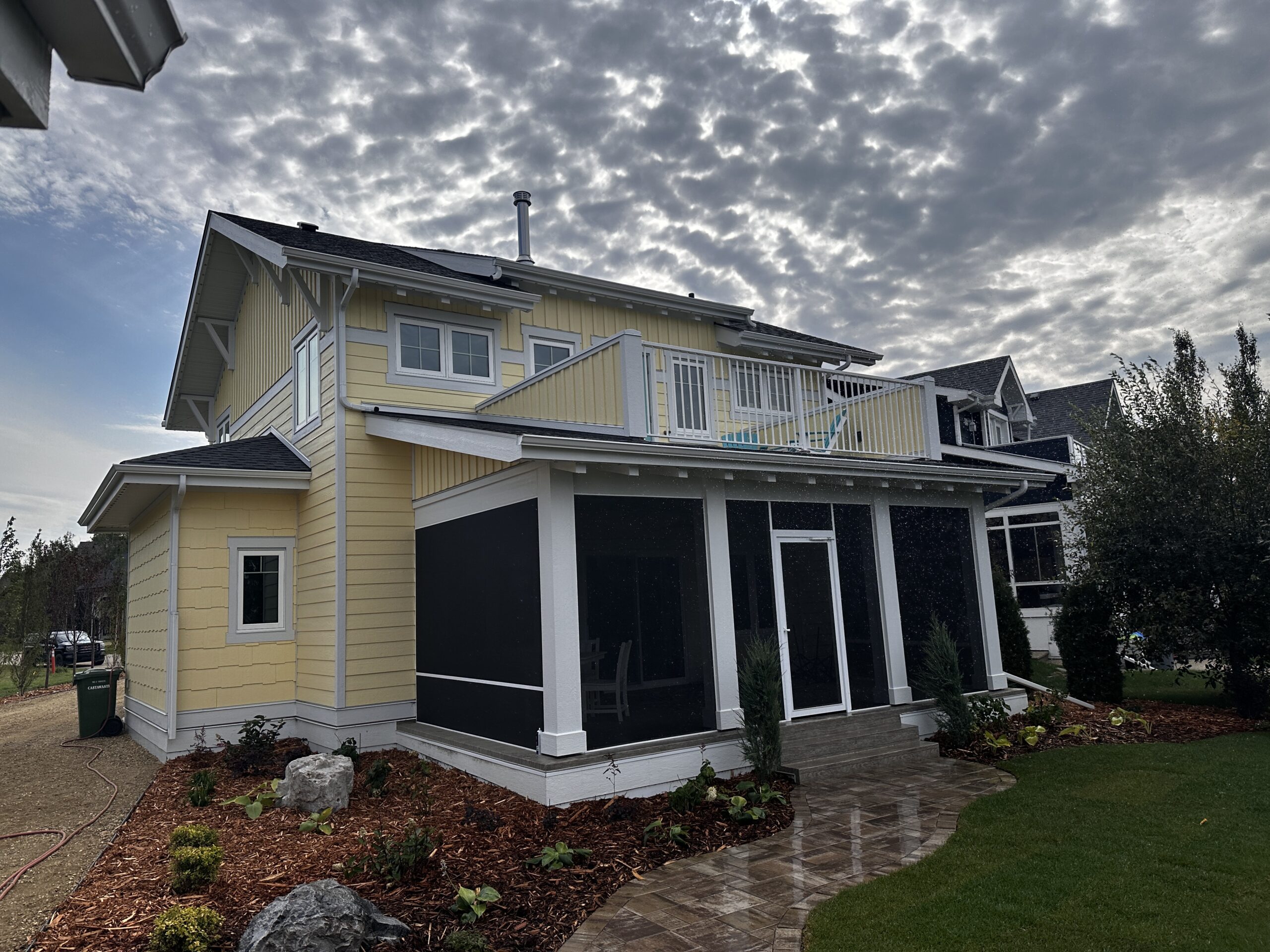 back side of a home with a covered, screened-in deck