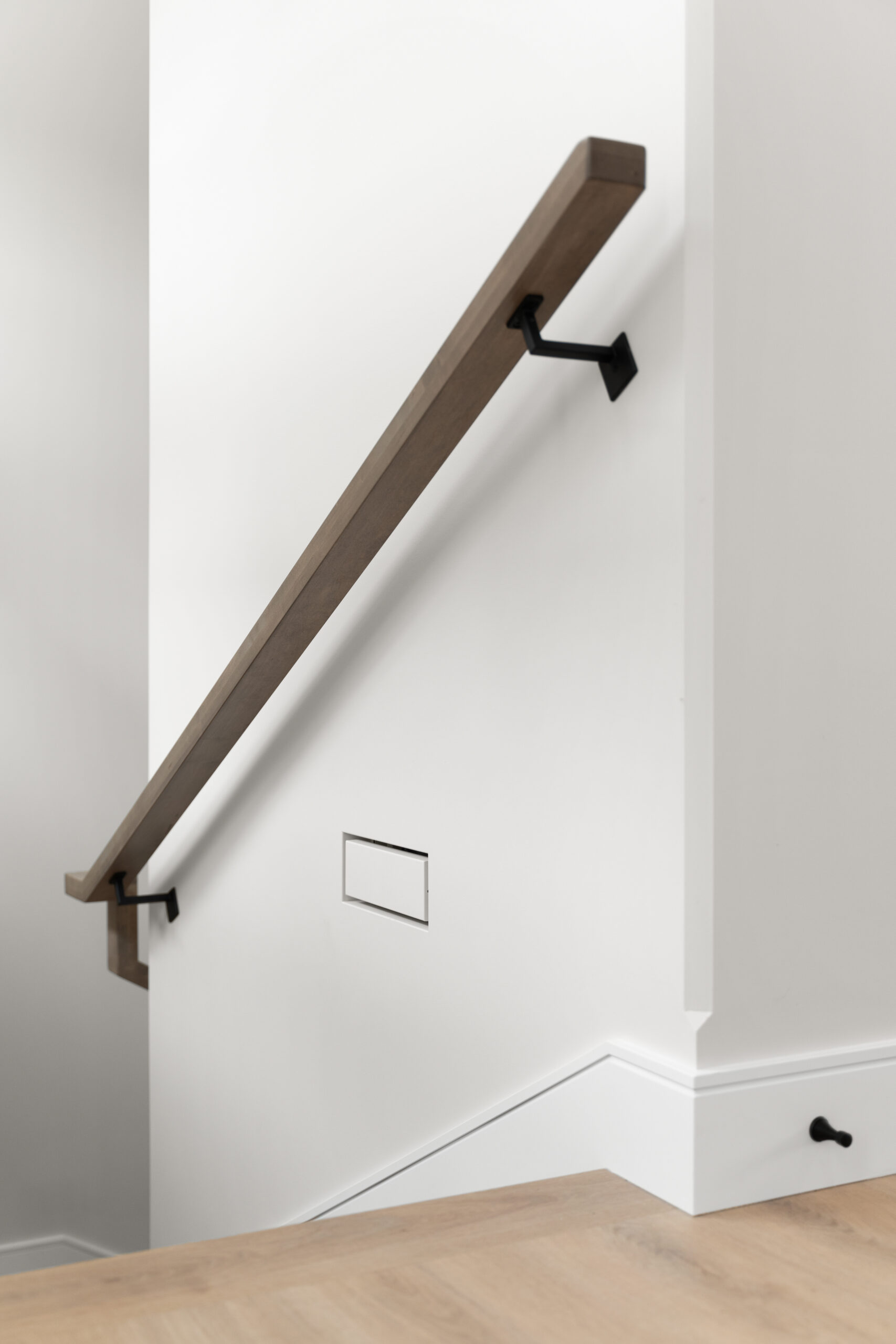 close-up of stair railing, air supply, and baseboard details in a net zero home