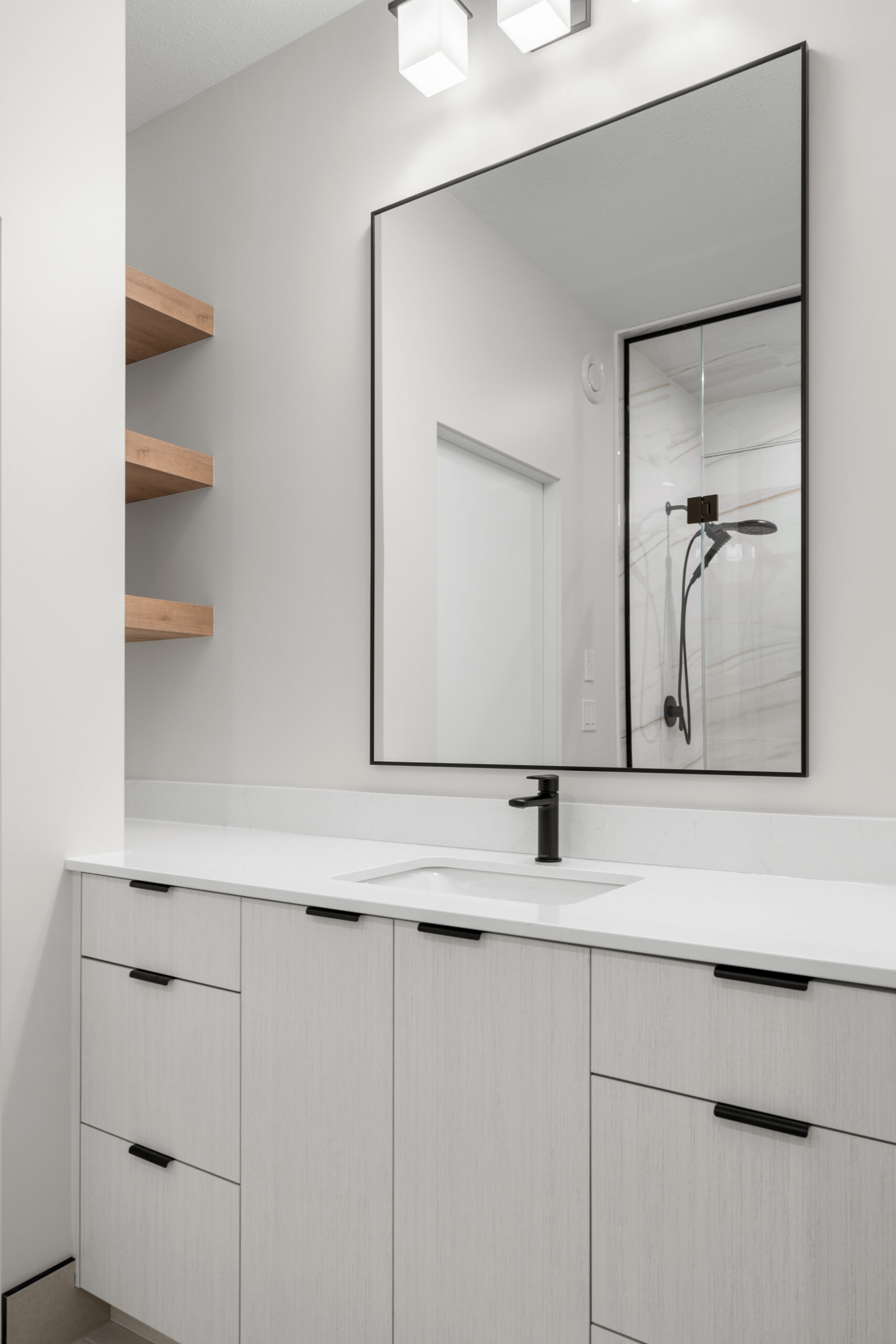 master ensuite sink with floating shelf storage in a net zero home