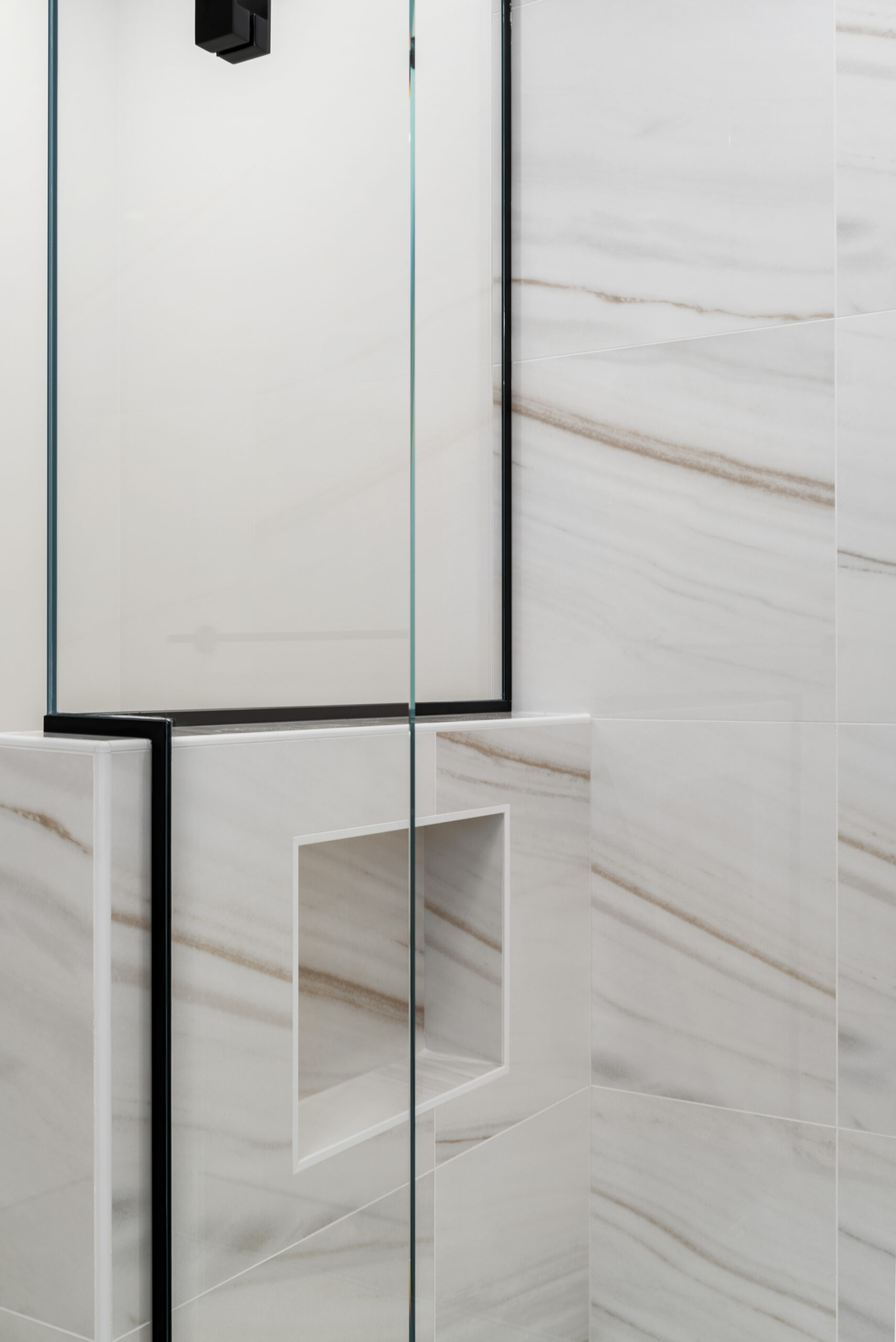 close-up of glass shower surround in the ensuite of a net zero home