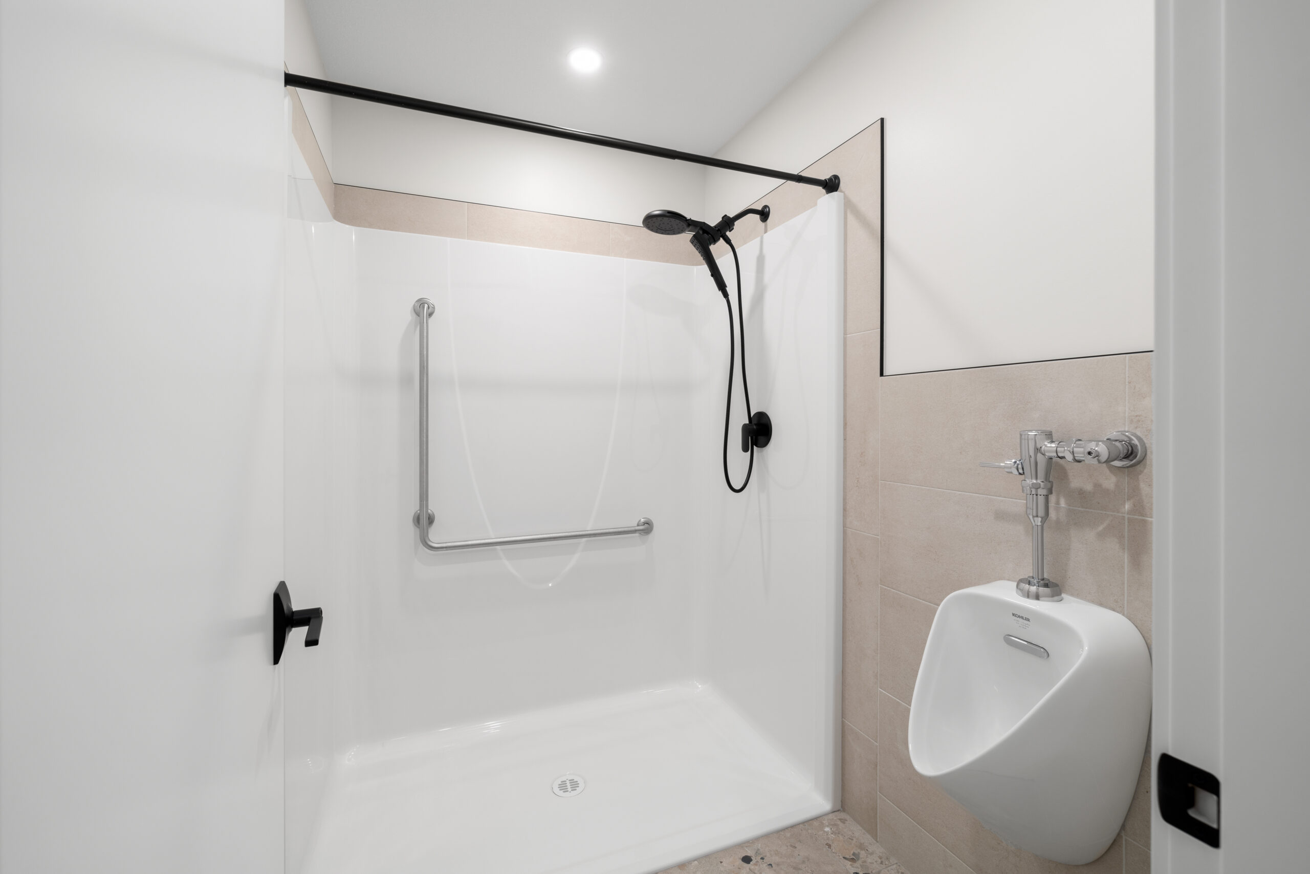 bathroom with urinal in the walk-out basement of a net zero home