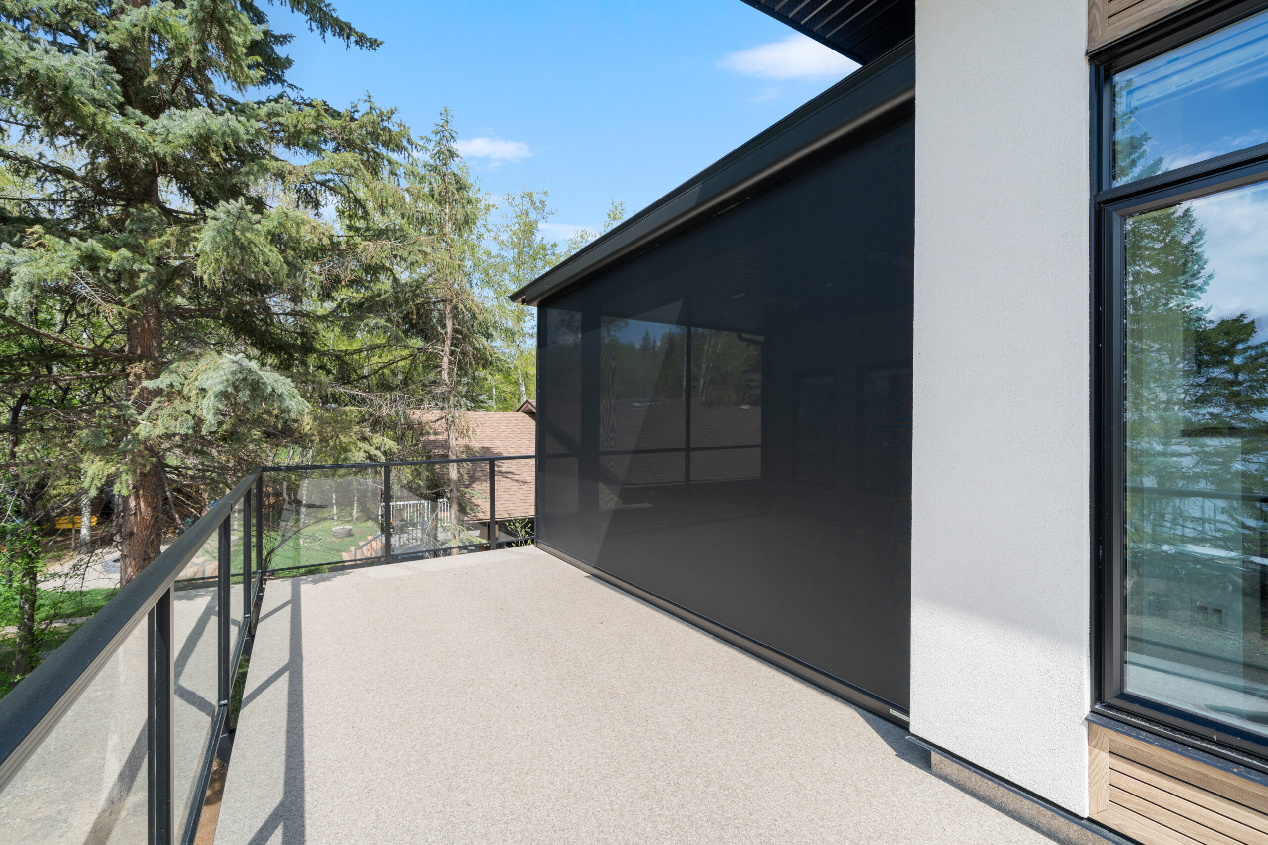 power retractable awning on second story deck rear exterior of a net-zero home